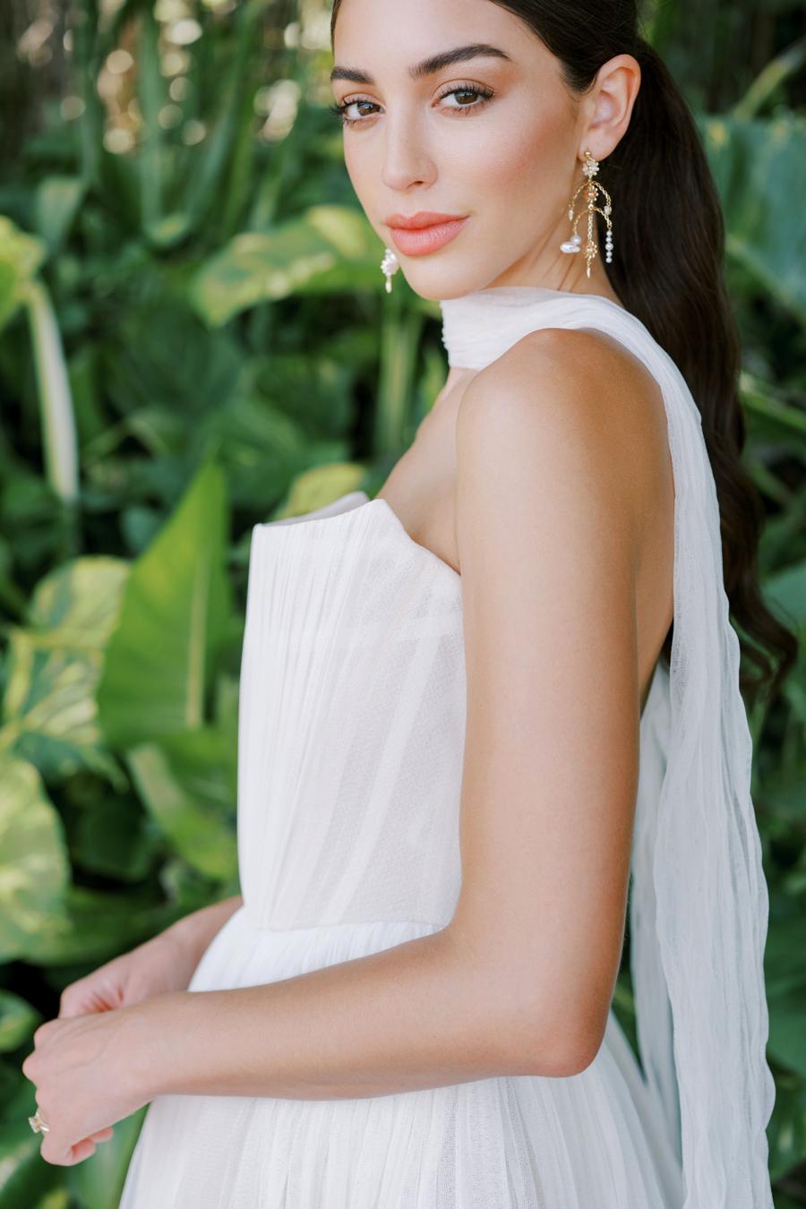 Introducing the Bridget Corset Gown, a modern twist on the timeless ballgown silhouette. With its soft net tie and Georgian-style corsetry, this gown exudes romance and structure. Delicate tucks add an element of intrigue, creating a unique and elegant creation that embodies contemporary style. Crafted from soft netting, the Bridget Corset Gown is a perfect blend of modern and classic design.