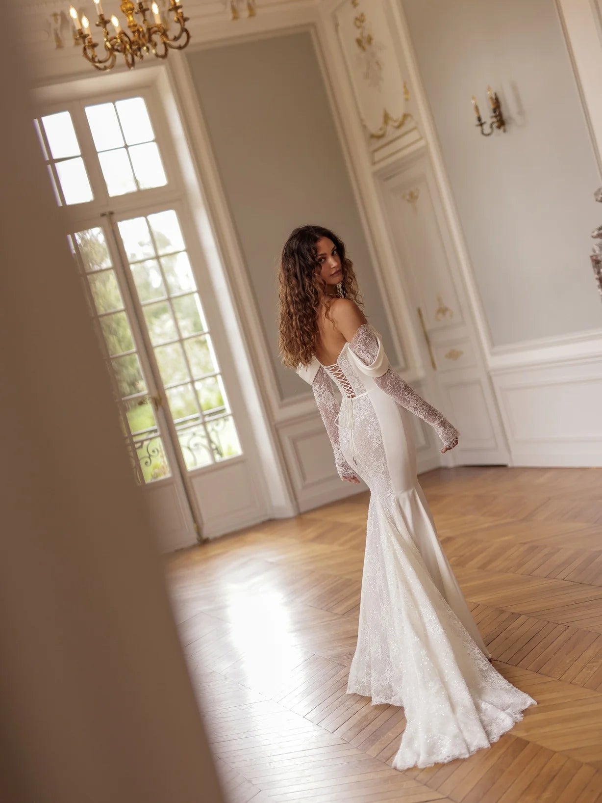 Indulge in the luxury of the Merryl Gown. This stunning mermaid gown features a sweetheart neckline adorned with draped satin, along with cold-shoulders and guipure sleeves for a sophisticated touch. The side satin panels and guipure bodice and skirt add a touch of modesty to this elegant piece.