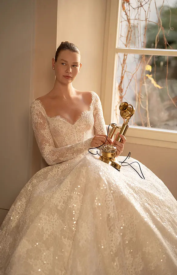 Indulge in the ultimate luxury with our Robe Mavi - a princess gown fit for royalty. Crafted from luxurious lace and adorned with delicate sequins, this elegant gown boasts a long train and long sleeves for a regal look. Stand out and shine with a touch of sparkle.