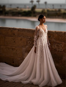 Indulge in timeless elegance with our Robe Nina. Featuring a delicately crafted lace design and long sleeves, this wedding gown is the perfect choice for your special day. Experience the luxury and sophistication of our exclusive collection.