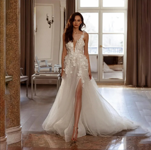Discover elegance and allure with the Robe Saira. The classic lace appliques add a touch of romance, while the A-Line silhouette accentuates your curves. The daring side high slit adds a sexy and modern twist. Walk down the aisle with confidence and grace in this timeless bridal gown.