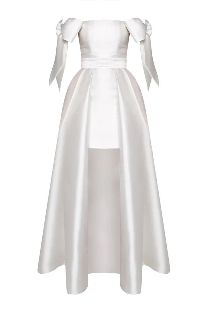 Crafted from luxurious silk and wool, the Margaret Dress offers a refined blend of texture and structure. Its innovative convertible design features a removable overskirt layered over a tailored midi pencil skirt, allowing for seamless transitions between sophisticated elegance and modern versatility. Ideal for those who appreciate expert craftsmanship and adaptable style.