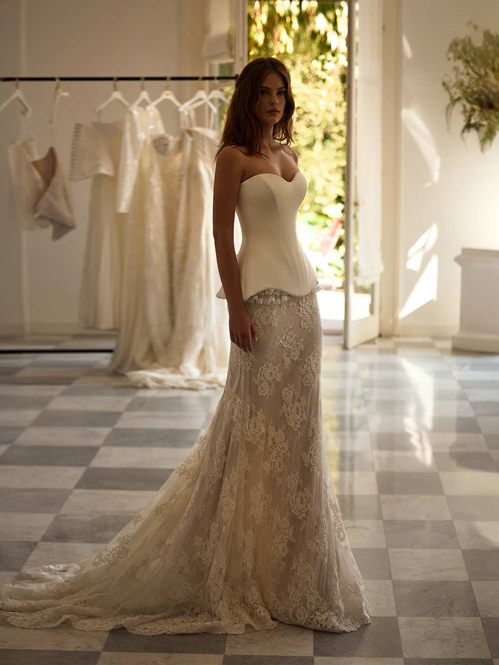 Experience the regal elegance and timeless grace of the Joely Gown. Featuring a flattering sweet-heart neckline and hidden boning, this gown creates a structured fit that elongates the silhouette and defines the waist. The lace-up back closure adds a touch of luxury, while the matching skirt completes the bridal look.