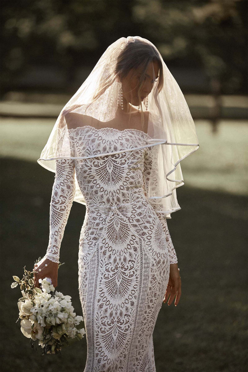The Nathalia Gown exudes European charm with delicate textures and refined elegance. Its intricate trims and panelling evoke a romantic garden ambience, perfect for any special occasion. Embrace its timeless beauty and feel like a true fashion icon.