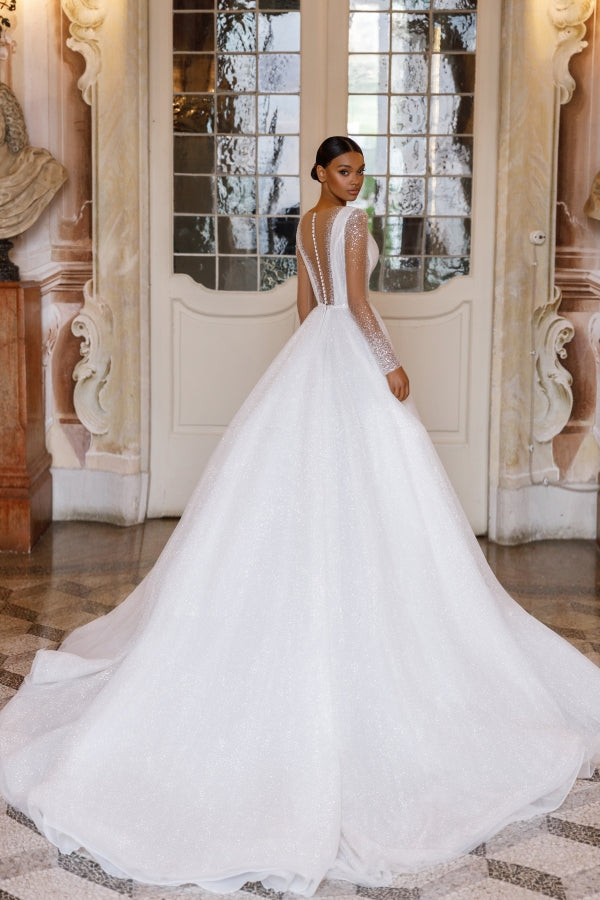 Be the belle of the ball in the Fabienne Gown! This exquisite sparkling A-line wedding bridal gown exudes elegant chic. Dazzle on your special day and make a statement with this stunning dress.