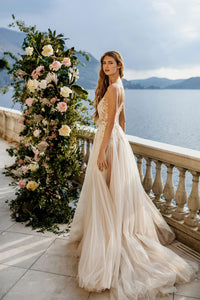 Create magical memories in the Antonella Dress. This sophisticated gown ensures your special day is filled with tenderness and everlasting beauty. Let its timeless design captivate you as you gracefully glide down the aisle!