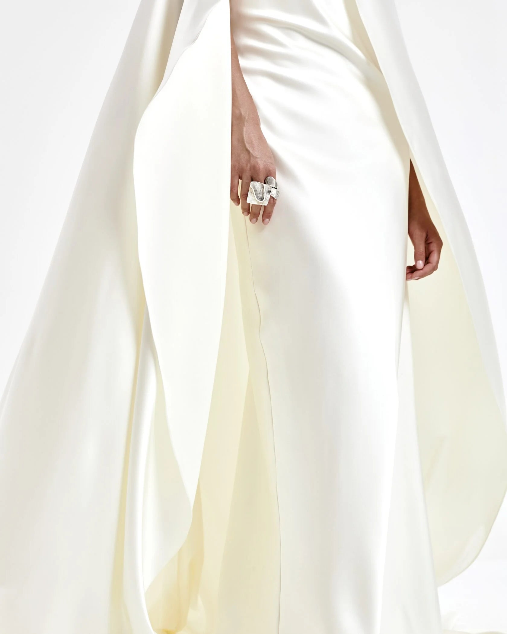 A laconic cape with a smooth texture — a luxurious attribute of the image that emphasizes the elegance and inner strength of its owner. The soft overflow of the fabric, the exquisite silhouette and train make the product expressive and self-sufficient. The composition was chosen consciously: the material does not wrinkle, retains its shape and provides an impeccable appearance throughout the evening. Becomes the final chord in a special event without requiring additional details. 