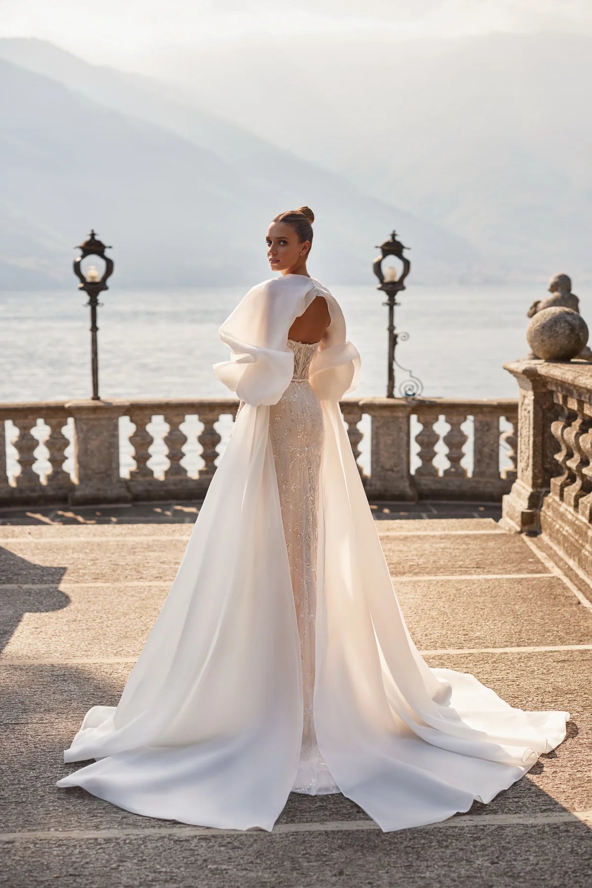 Experience elegance and glamour in the Caitlyn Gown, featuring stunning Chantilly lace and intricate embroidery of glitter, pearls, and beads. The sweetheart neckline, concealed laces, and detachable long sleeves provide the perfect fit. Complete your look with a gorgeous organza cape, embellished with delicate details and lace inserts. Make a statement with this captivating dress, perfectly finished with a touch of buttons in the back.
