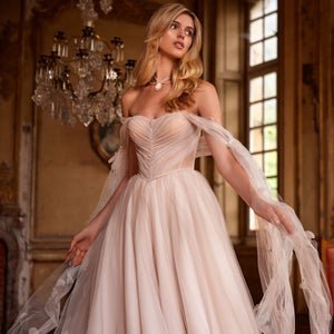Get ready to turn heads in our Dress Fiona! This soft-colored A-line dress features a delicate train and a shoulder-baring corset with removable cups and a lace-up back. Adorned with hand-embroidered petals and mesh sleeves, the lightweight and airy mesh and organza skirt is cinched at the waist with an embroidered belt. Be effortlessly elegant and playful in this one-of-a-kind dress!