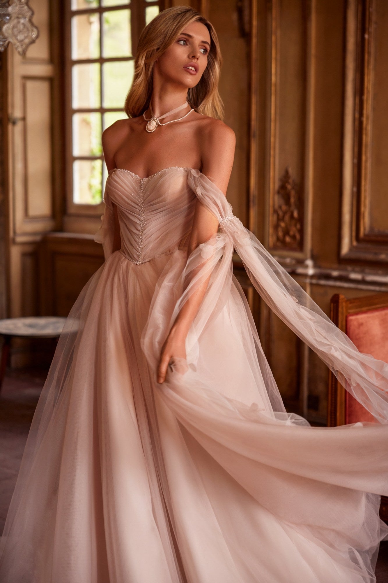 Get ready to turn heads in our Dress Fiona! This soft-colored A-line dress features a delicate train and a shoulder-baring corset with removable cups and a lace-up back. Adorned with hand-embroidered petals and mesh sleeves, the lightweight and airy mesh and organza skirt is cinched at the waist with an embroidered belt. Be effortlessly elegant and playful in this one-of-a-kind dress!