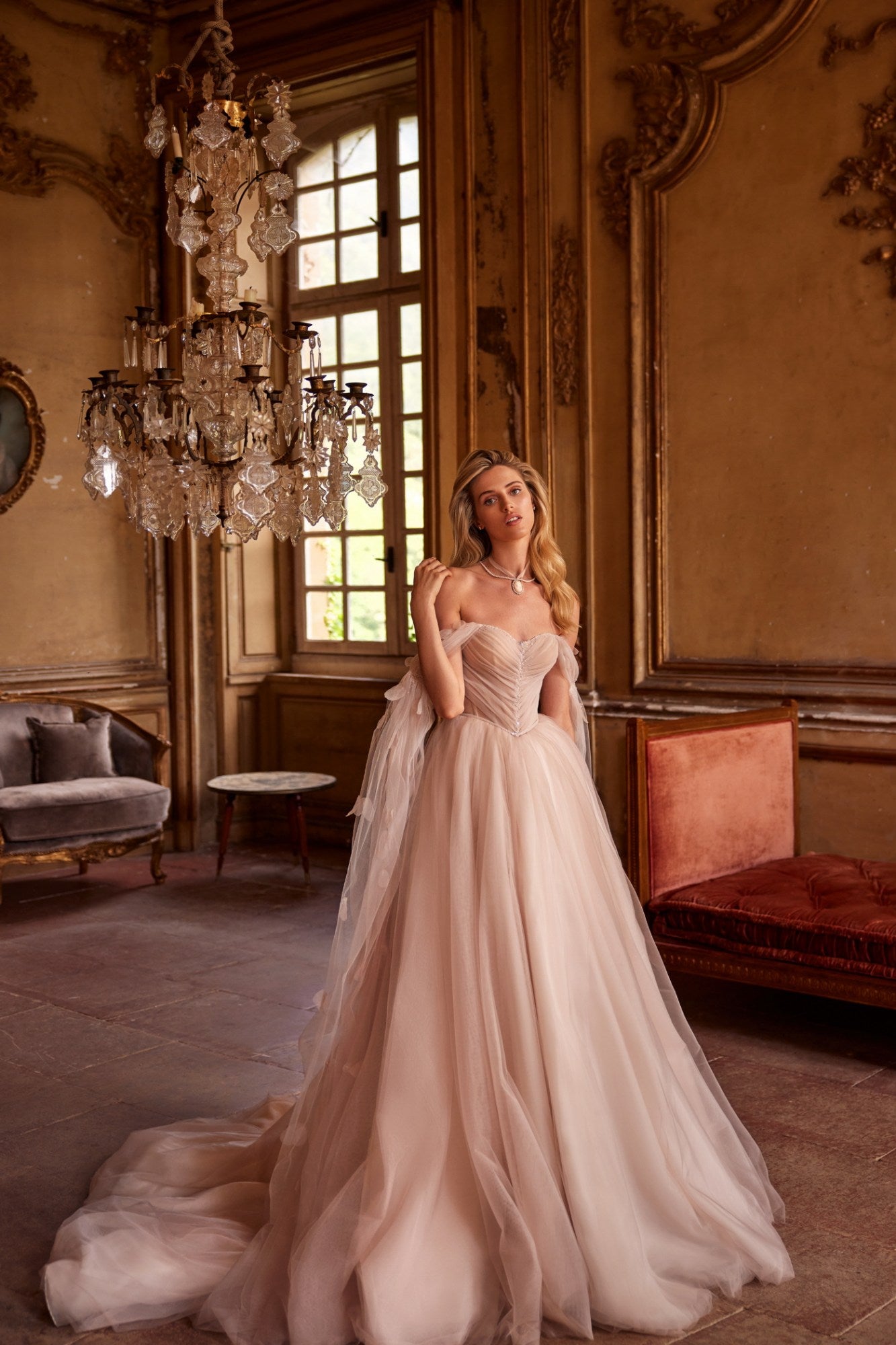 Get ready to turn heads in our Dress Fiona! This soft-colored A-line dress features a delicate train and a shoulder-baring corset with removable cups and a lace-up back. Adorned with hand-embroidered petals and mesh sleeves, the lightweight and airy mesh and organza skirt is cinched at the waist with an embroidered belt. Be effortlessly elegant and playful in this one-of-a-kind dress!