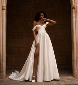 Indulge in luxury with our Robe Ivette. Made from smooth satin, this off-shoulder wedding dress exudes elegance and charm. Its simple design and lightweight material make it perfect for a beach wedding. Complete your bridal look with our exclusive Robe Ivette and feel like a true bride on your special day.