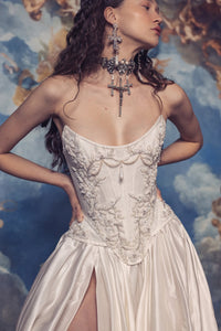 Indulge in luxury with the Isabelle Gown. Crafted with a structured corset dress, this gown features intricate Indian embroidery on the bodice and a voluminous skirt. Made from high-quality silk taffeta, it exudes elegance and sophistication, making it the perfect choice for any formal occasion. The thigh high slit adds a touch of allure to this stunning gown.