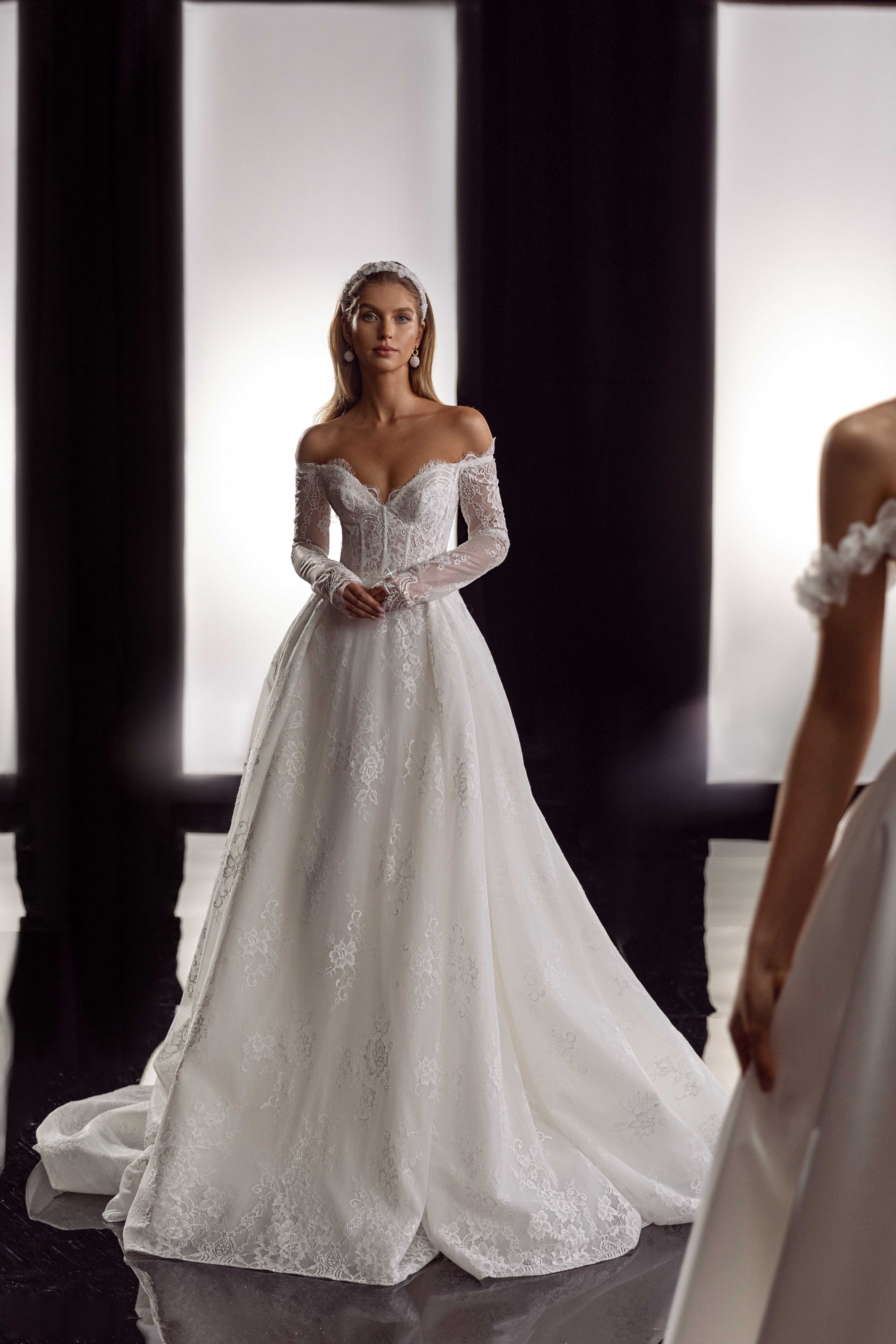 This Bernita Gown exudes elegance with its exquisite French lace and romantic allure. The accompanying veil adds a touch of chic and completes the bridal look. Perfect for any sophisticated bride seeking a timeless and refined wedding gown.