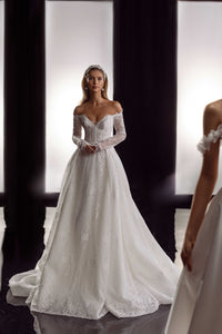 This Bernita Gown exudes elegance with its exquisite French lace and romantic allure. The accompanying veil adds a touch of chic and completes the bridal look. Perfect for any sophisticated bride seeking a timeless and refined wedding gown.
