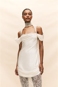 The Belleza Dress is a unique bridal gown that seamlessly combines delicate, vintage-inspired lace with luxurious ruched silk satin. With its elegant and playful silhouette, this dress is perfect for the modern bride seeking a one-of-a-kind look on her special day. Crafted with quality materials, it offers a sultry and luxurious feel.