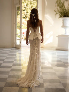 Experience the regal elegance and timeless grace of the Joely Gown. Featuring a flattering sweet-heart neckline and hidden boning, this gown creates a structured fit that elongates the silhouette and defines the waist. The lace-up back closure adds a touch of luxury, while the matching skirt completes the bridal look.