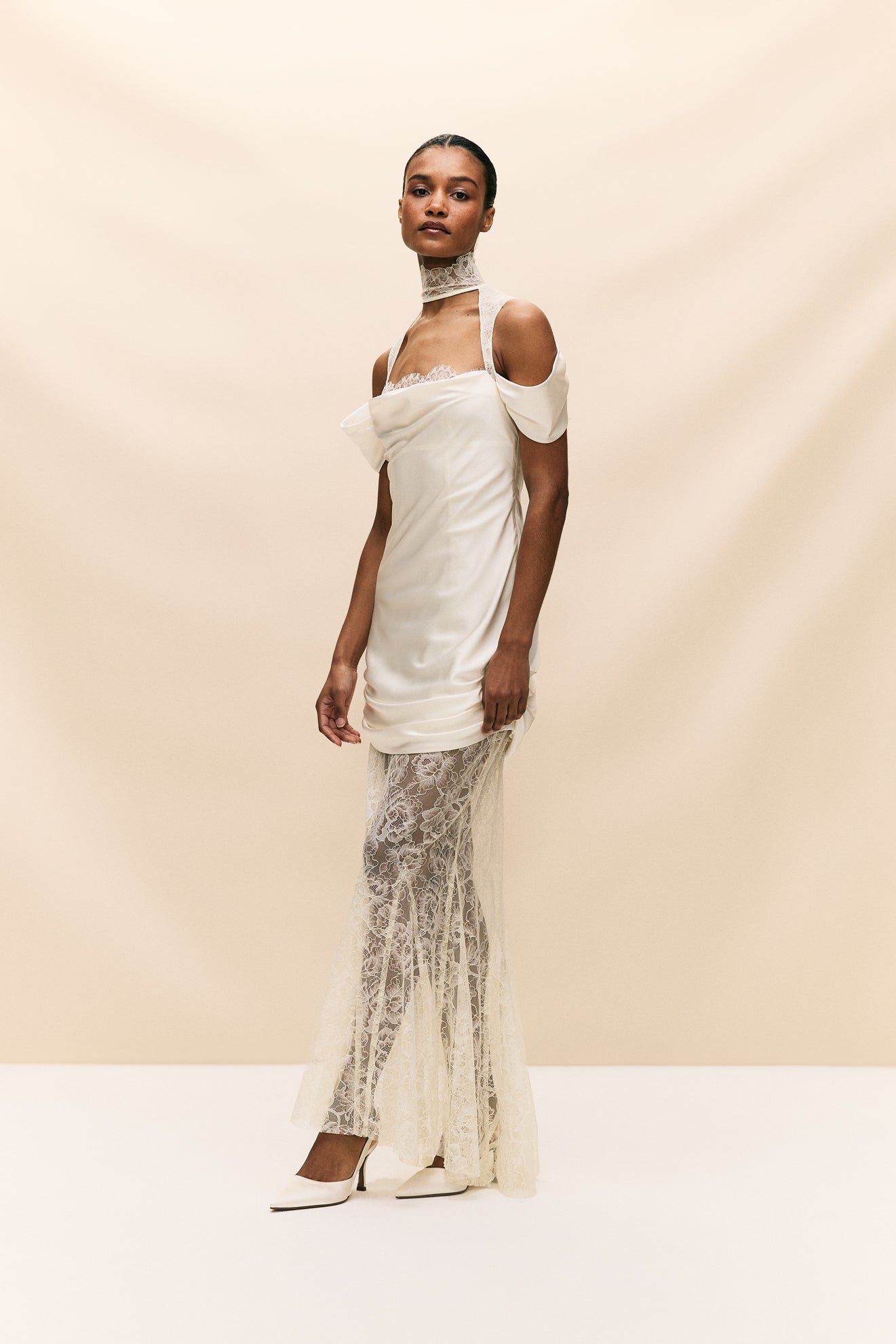 The Belleza Dress is a unique bridal gown that seamlessly combines delicate, vintage-inspired lace with luxurious ruched silk satin. With its elegant and playful silhouette, this dress is perfect for the modern bride seeking a one-of-a-kind look on her special day. Crafted with quality materials, it offers a sultry and luxurious feel.