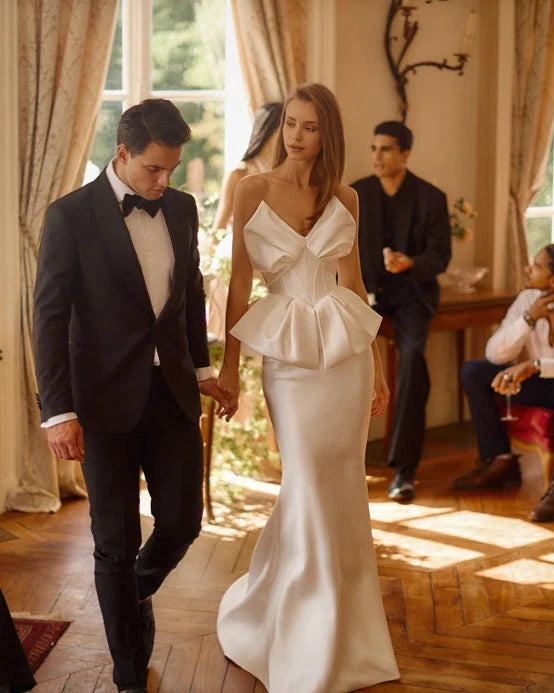 Elevate your evening wardrobe with the Nila Gown. The mermaid silhouette flatters your figure, while the bow-shaped corset neckline and peplum add a touch of elegance. Made with smooth fabric and a lace-up back, this dress is both sophisticated and comfortable. Perfect for any special occasion, make a statement in the Nila Gown.