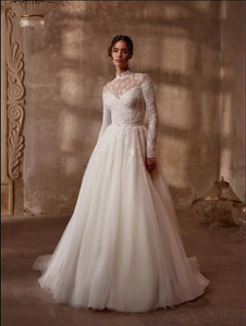 Indulge in timeless elegance with the Robe Mercer. This luxurious vintage wedding dress features intricate lace detailing, a stunning ball gown silhouette, and long sleeves for a touch of grace and sophistication. Perfect for the bride seeking a romantic and classic look on her special day.