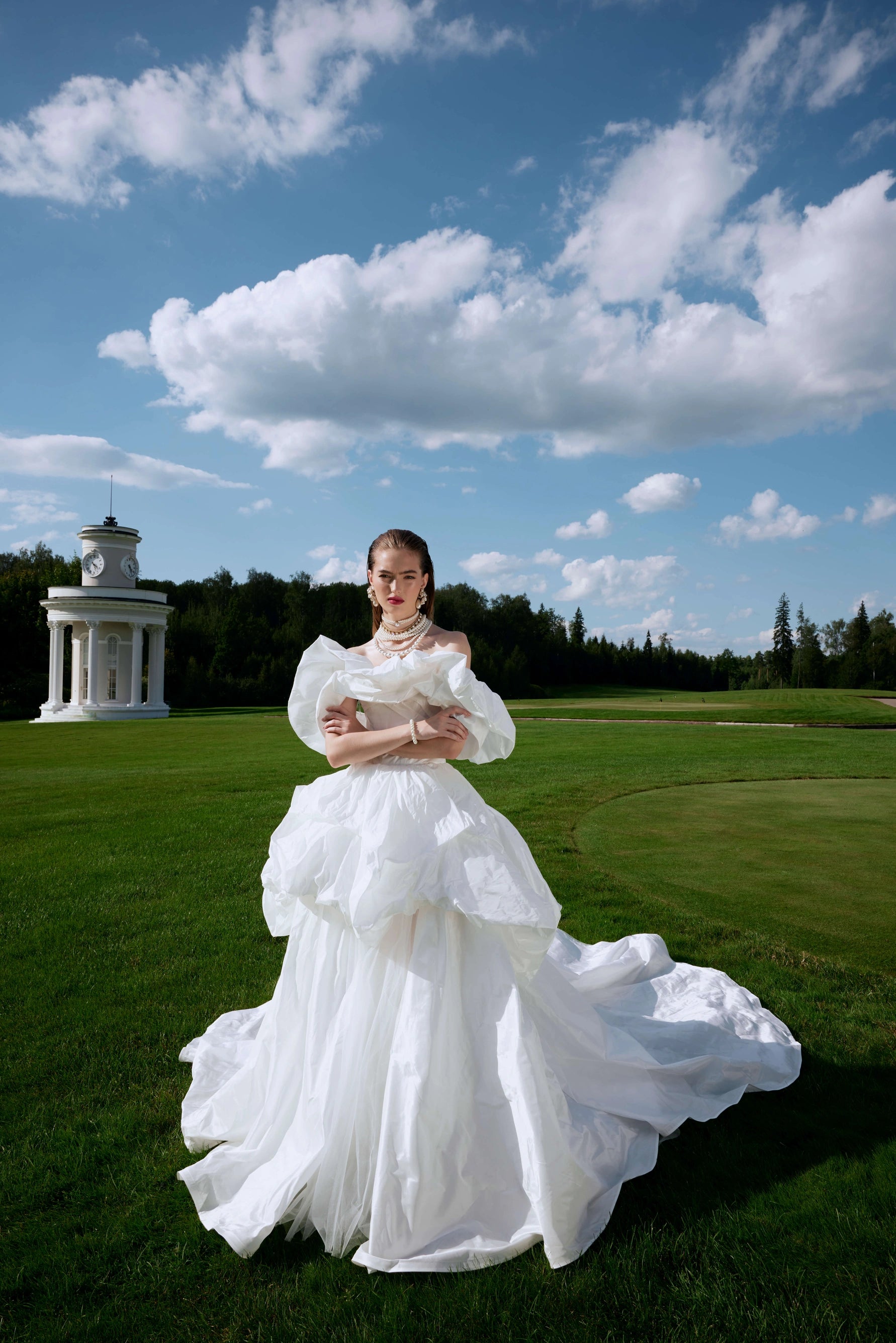 Elevate your special day with the Fenny Gown. This ball-gown silhouette wedding dress features voluminous dropped straps and a hook-back closure. Crafted with luxurious taffeta, it exudes elegance and sophistication. Say "I do" in style with the Fenny Gown.