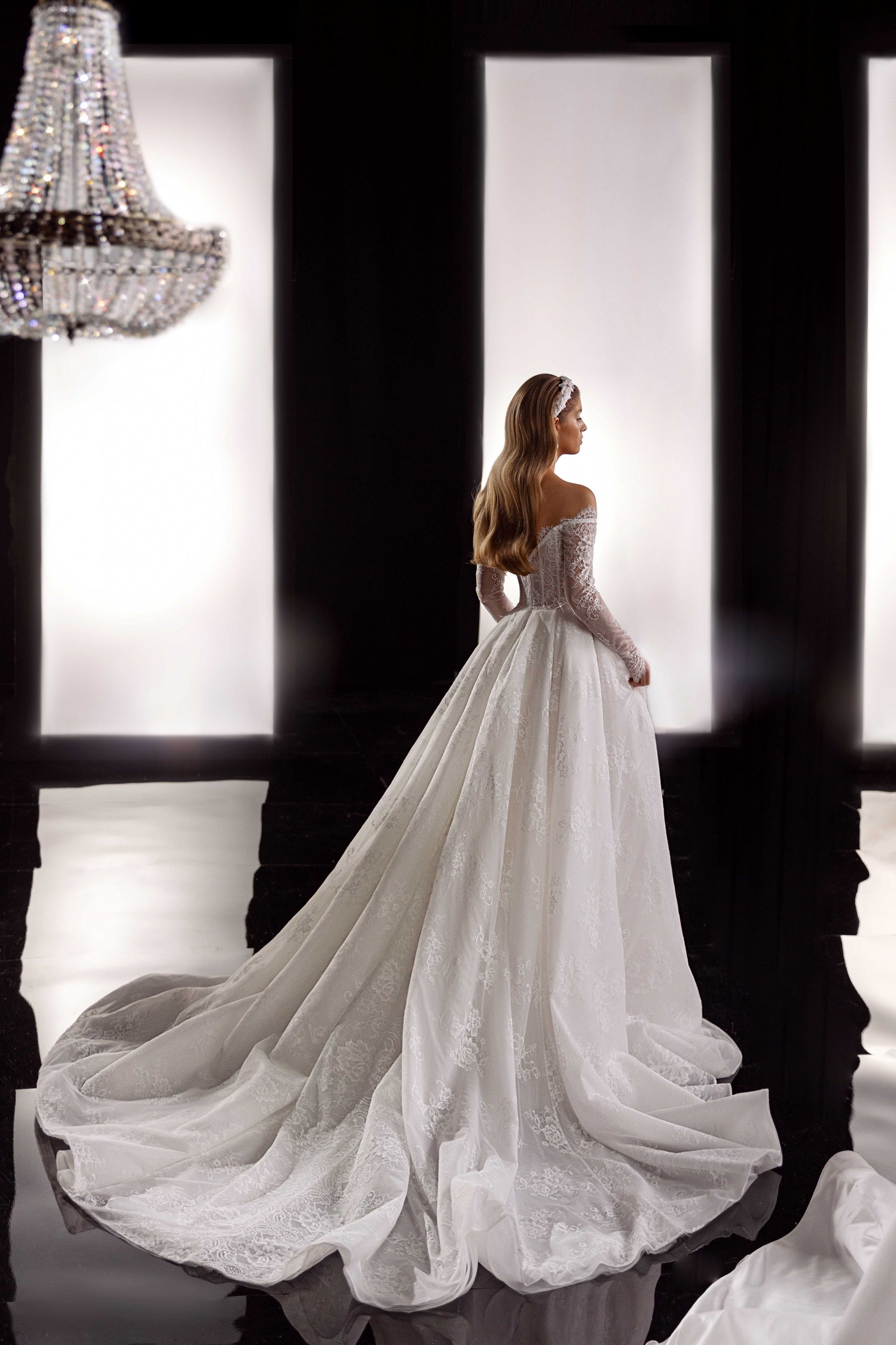 This Bernita Gown exudes elegance with its exquisite French lace and romantic allure. The accompanying veil adds a touch of chic and completes the bridal look. Perfect for any sophisticated bride seeking a timeless and refined wedding gown.