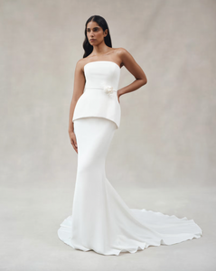 Experience luxury with the Clara Crepe Gown. Made from 100% satin silk crepe, this strapless gown offers a comfortable and elegant fit. The drop waist adds a touch of sophistication, making it the perfect choice for any special occasion. Available in a beautiful off-white color.