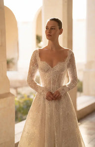 Indulge in the ultimate luxury with our Robe Mavi - a princess gown fit for royalty. Crafted from luxurious lace and adorned with delicate sequins, this elegant gown boasts a long train and long sleeves for a regal look. Stand out and shine with a touch of sparkle.