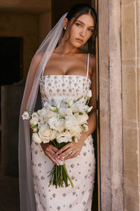 Robe Martine is hand embellished with details that will have you looking your most glamorous on your special day.&nbsp;The attention to detail is exquisite, as 'Martine' is beautifully embellished with faux pearls and silver crystals throughout. It's underpinned with our incredible corsetry boning to create a secure, structured fit to cinch your waist and it's finished by slender straps.