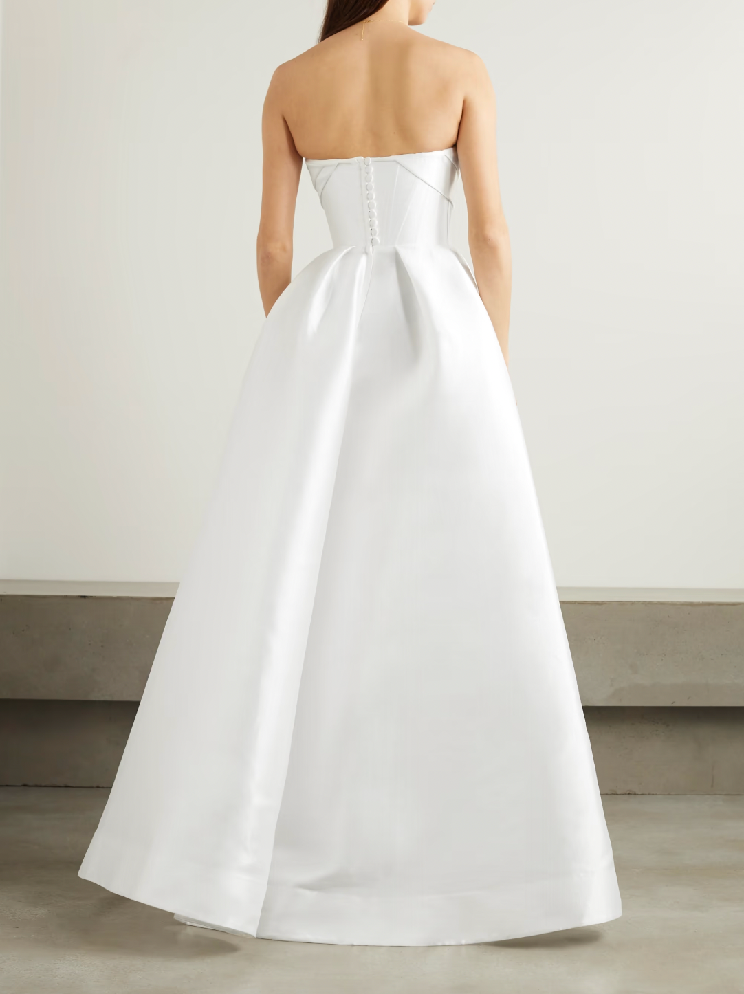'Isobel' gown is such an elegant choice for your special day. Crafted from white satin-faille with a lustrous finish, it has the signature sculptural bodice and a full skirt with pleats that add structure and volume.