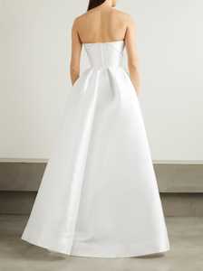'Isobel' gown is such an elegant choice for your special day. Crafted from white satin-faille with a lustrous finish, it has the signature sculptural bodice and a full skirt with pleats that add structure and volume.