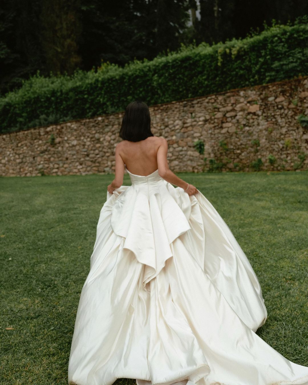 Get ready to walk down the aisle in style with our Romina Gown! This vintage-inspired wedding dress features a stunning backless design, elegant puff sleeves, and a flattering A-line silhouette. Made with soft, stain-resistant fabric, it's the perfect choice for your big day.