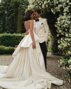 Get ready to walk down the aisle in style with our Romina Gown! This vintage-inspired wedding dress features a stunning backless design, elegant puff sleeves, and a flattering A-line silhouette. Made with soft, stain-resistant fabric, it's the perfect choice for your big day.
