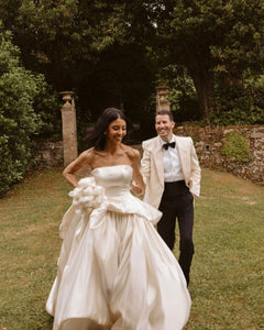Get ready to walk down the aisle in style with our Romina Gown! This vintage-inspired wedding dress features a stunning backless design, elegant puff sleeves, and a flattering A-line silhouette. Made with soft, stain-resistant fabric, it's the perfect choice for your big day.