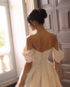 Discover the ultimate bridal elegance with our Bianca Gown! This exquisite princess-style gown features chic detailing and a stunning long train that will make you feel like royalty on your special day. Say "I do" in style with this elegant and timeless piece.