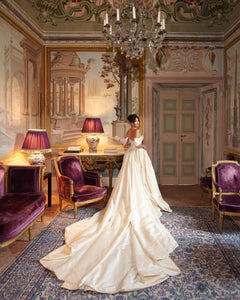 Discover the ultimate bridal elegance with our Bianca Gown! This exquisite princess-style gown features chic detailing and a stunning long train that will make you feel like royalty on your special day. Say "I do" in style with this elegant and timeless piece.