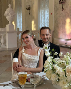 Get ready to dazzle on your special day with the Versy Gown. The fitted silhouette is enhanced by a relief corset made of transparent mesh and lace, adorned with asymmetrical pearl threads. The whimsical silhouette skirt features scattered pearl threads and removable stars for a unique, ethereal touch. Say "I do" in style with the Versy Gown.