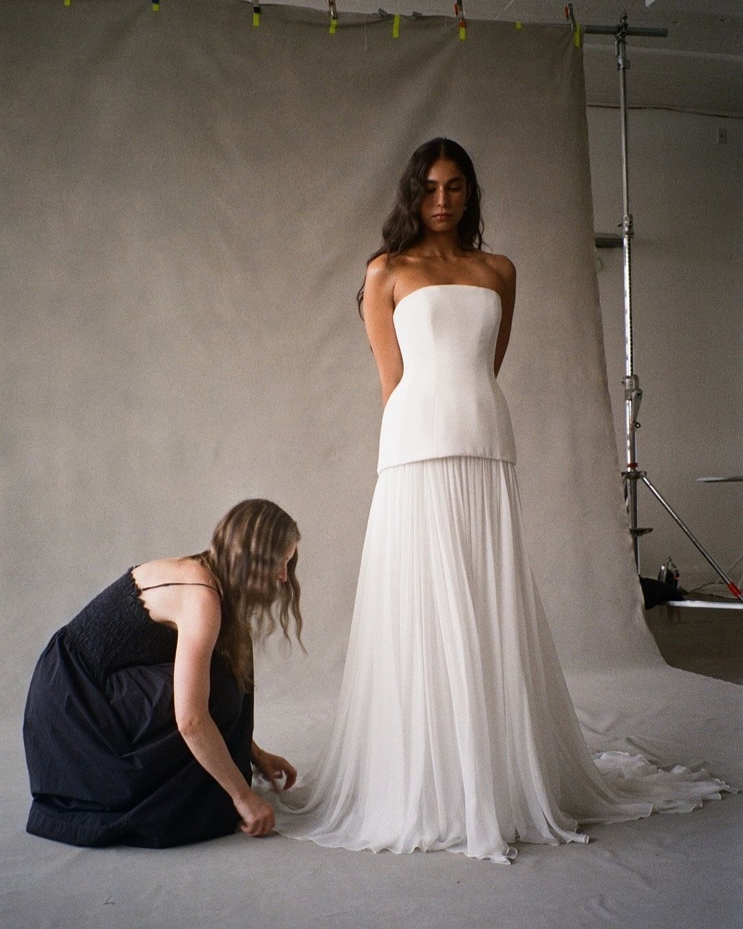 Experience luxury with the Clara Crepe Gown. Made from 100% satin silk crepe, this strapless gown offers a comfortable and elegant fit. The drop waist adds a touch of sophistication, making it the perfect choice for any special occasion. Available in a beautiful off-white color.