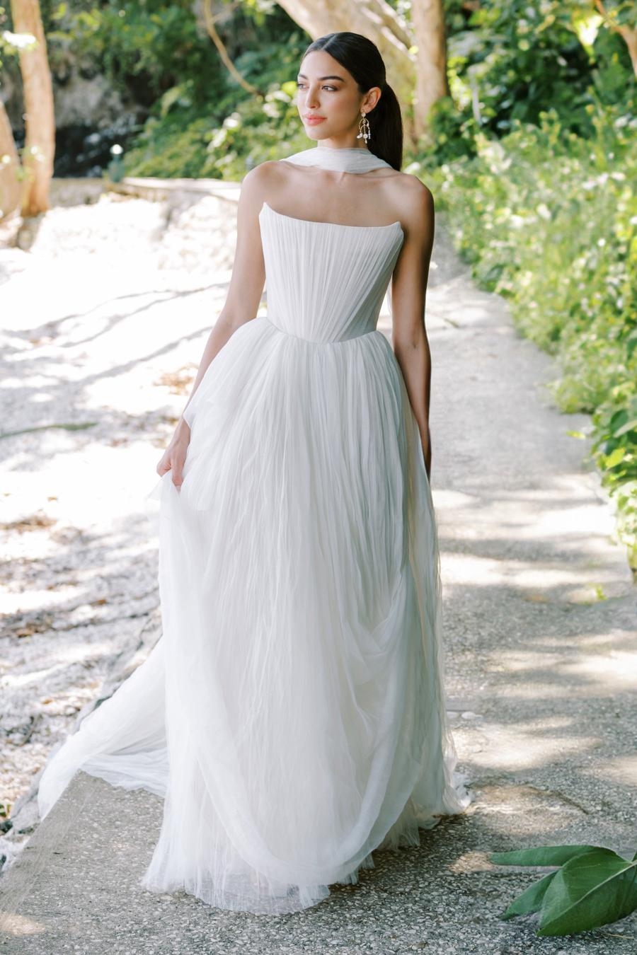 Introducing the Bridget Corset Gown, a modern twist on the timeless ballgown silhouette. With its soft net tie and Georgian-style corsetry, this gown exudes romance and structure. Delicate tucks add an element of intrigue, creating a unique and elegant creation that embodies contemporary style. Crafted from soft netting, the Bridget Corset Gown is a perfect blend of modern and classic design.