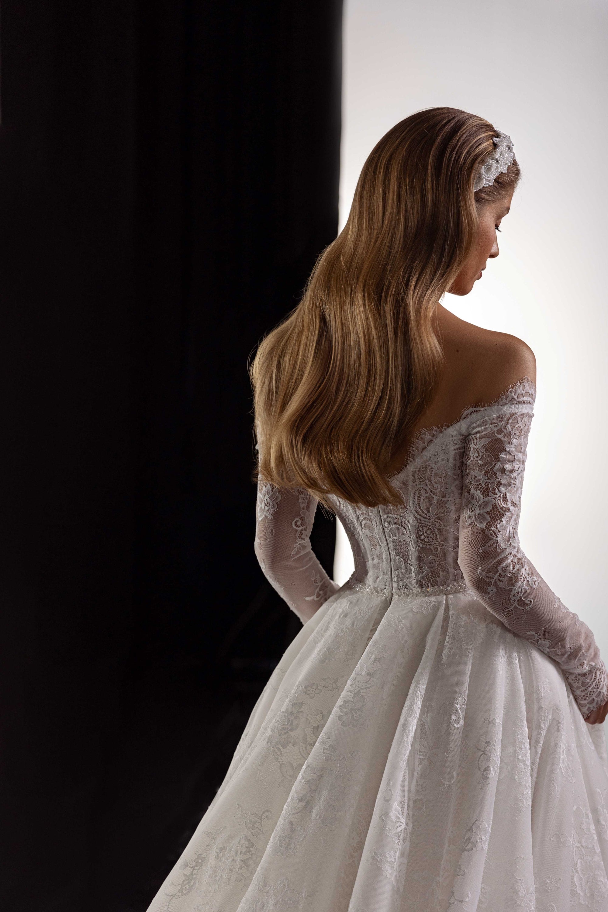 This Bernita Gown exudes elegance with its exquisite French lace and romantic allure. The accompanying veil adds a touch of chic and completes the bridal look. Perfect for any sophisticated bride seeking a timeless and refined wedding gown.