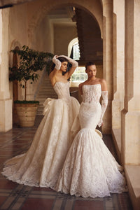 Feel like a true princess in our Melody Gown. The Alençon lace mermaid design and strapless scoop neckline will accentuate your figure, while the signature satin Pnina bow adds a touch of elegance. Complete your look with the coordinating lace bolero and matching gloves for the perfect fairytale wedding.