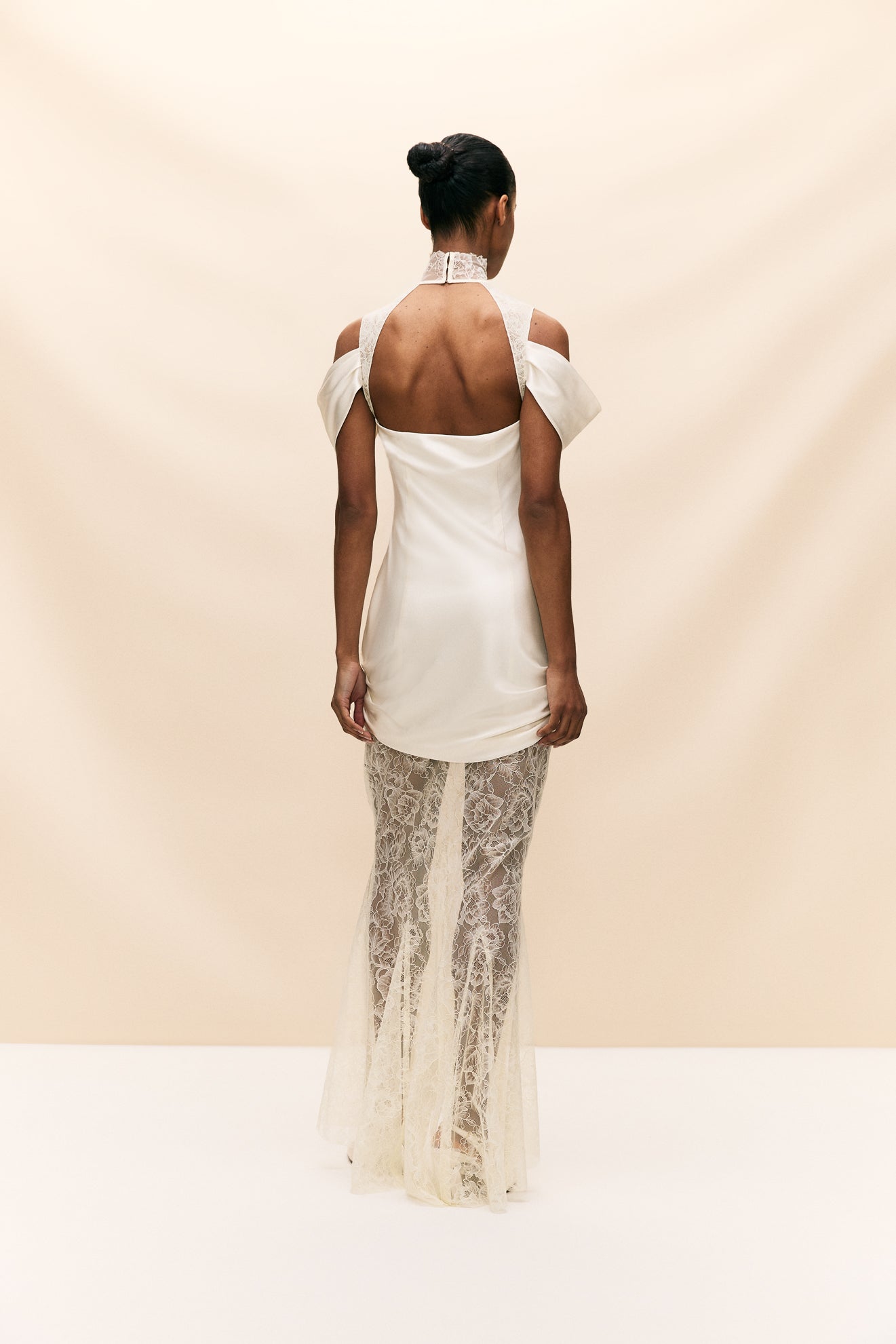 The Belleza Dress is a unique bridal gown that seamlessly combines delicate, vintage-inspired lace with luxurious ruched silk satin. With its elegant and playful silhouette, this dress is perfect for the modern bride seeking a one-of-a-kind look on her special day. Crafted with quality materials, it offers a sultry and luxurious feel.