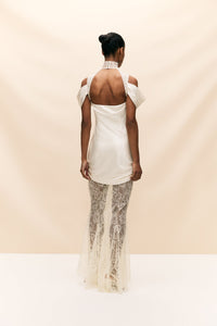 The Belleza Dress is a unique bridal gown that seamlessly combines delicate, vintage-inspired lace with luxurious ruched silk satin. With its elegant and playful silhouette, this dress is perfect for the modern bride seeking a one-of-a-kind look on her special day. Crafted with quality materials, it offers a sultry and luxurious feel.