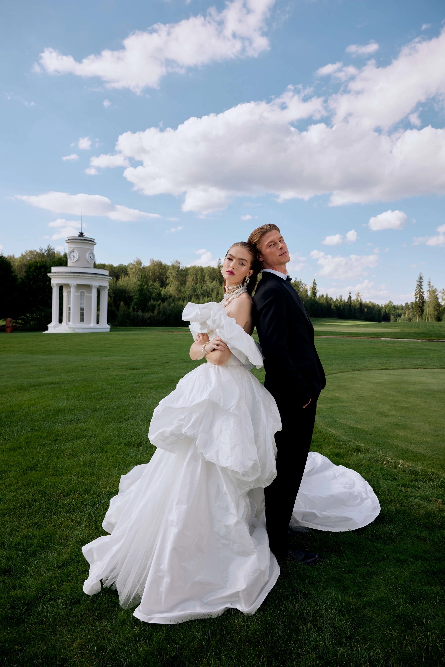 Elevate your special day with the Fenny Gown. This ball-gown silhouette wedding dress features voluminous dropped straps and a hook-back closure. Crafted with luxurious taffeta, it exudes elegance and sophistication. Say "I do" in style with the Fenny Gown.