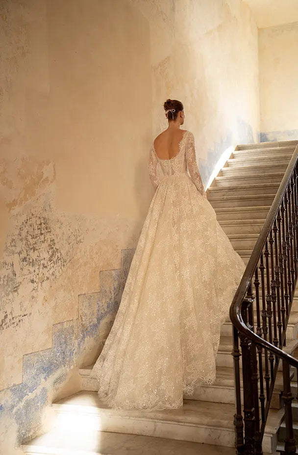 Indulge in the ultimate luxury with our Robe Mavi - a princess gown fit for royalty. Crafted from luxurious lace and adorned with delicate sequins, this elegant gown boasts a long train and long sleeves for a regal look. Stand out and shine with a touch of sparkle.