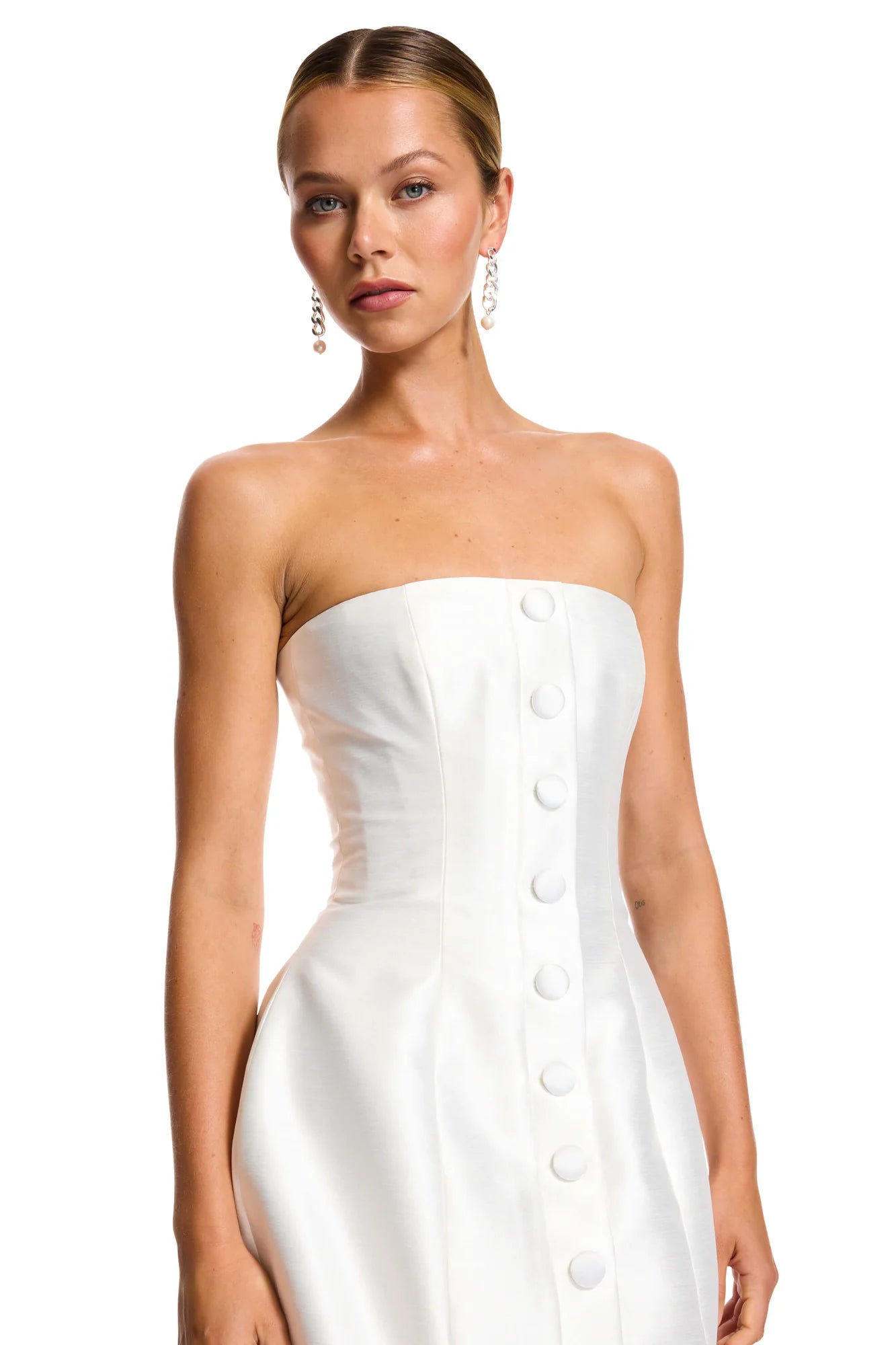 Looking for the perfect dress to stand out at any event? Look no further than the Lavana Mini Dress! With its fully corseted, strapless design and distinctive oversized buttons, you'll be the talk of the town. Available in bright ivory to suit any style.