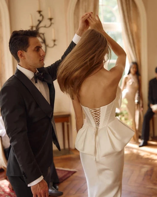 Elevate your evening wardrobe with the Nila Gown. The mermaid silhouette flatters your figure, while the bow-shaped corset neckline and peplum add a touch of elegance. Made with smooth fabric and a lace-up back, this dress is both sophisticated and comfortable. Perfect for any special occasion, make a statement in the Nila Gown.