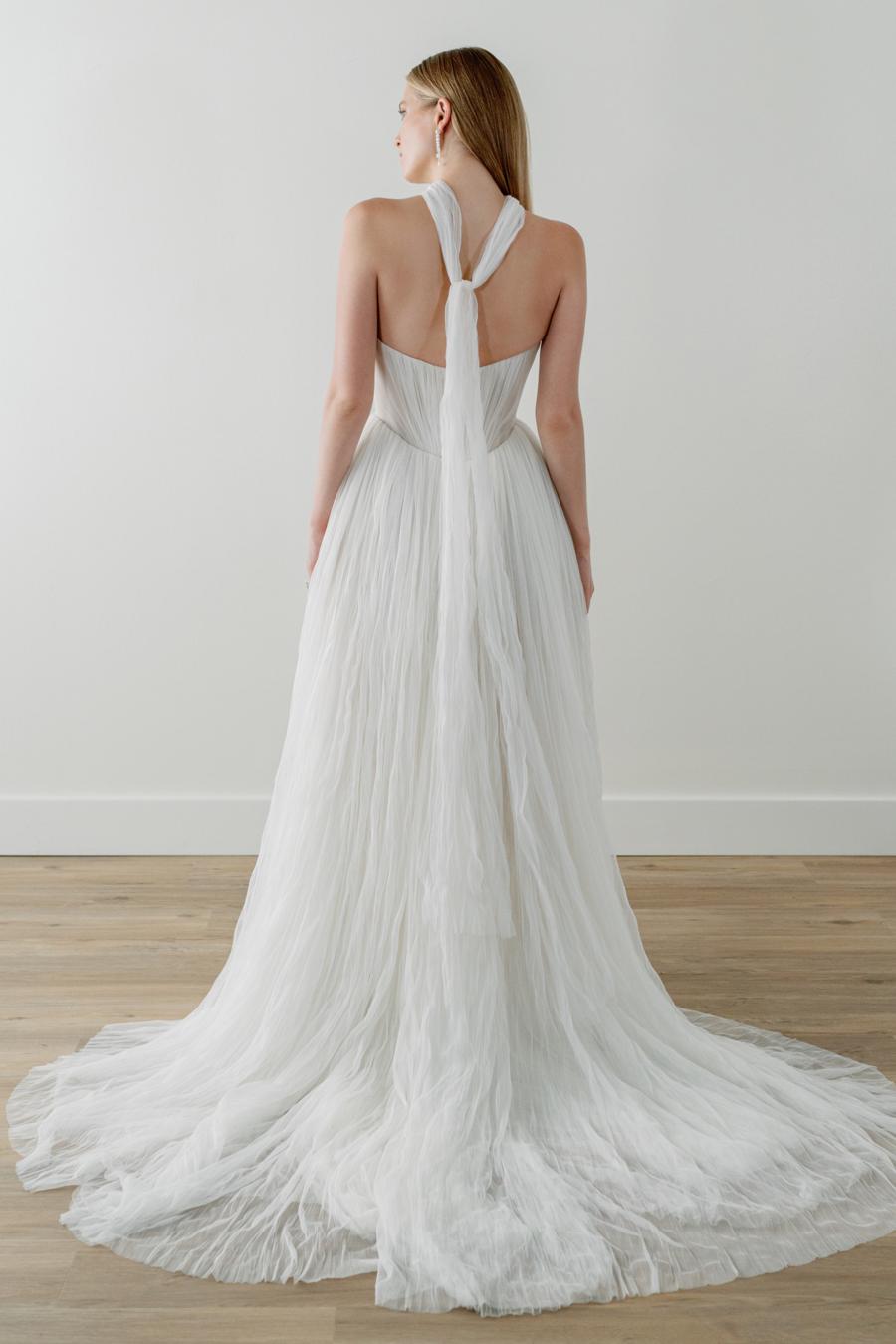 Introducing the Bridget Corset Gown, a modern twist on the timeless ballgown silhouette. With its soft net tie and Georgian-style corsetry, this gown exudes romance and structure. Delicate tucks add an element of intrigue, creating a unique and elegant creation that embodies contemporary style. Crafted from soft netting, the Bridget Corset Gown is a perfect blend of modern and classic design.