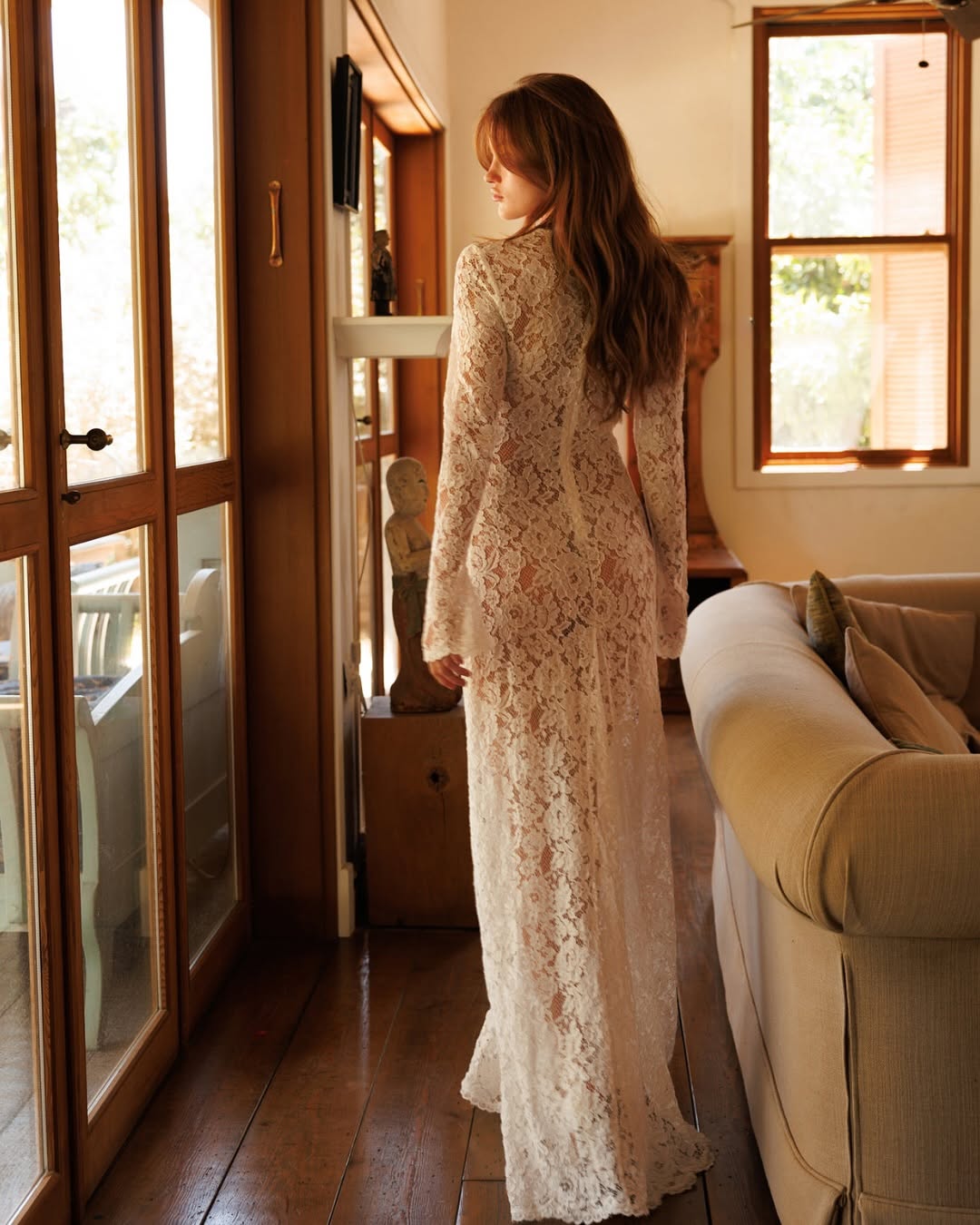 The Lauren Lace Dress blends vintage elegance with modern craftsmanship, inspired by a cherished wedding moment. Made from semi-sheer, finely woven lace, it strikes a delicate balance of allure and structure. Featuring a deep neckline, long sleeves, and a soft train, this dress captures timeless romance reminiscent of Jane Birkin’s classic crochet style. Its refined design offers a graceful silhouette that speaks to understated sophistication and memorable femininity.