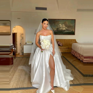 Be the bride of everyone's dreams with the Eva Gown. This chic and simple white satin dress exudes elegance and romance, making you feel like a fairytale princess on your special day. Say "I do" to this dreamy and stylish gown.